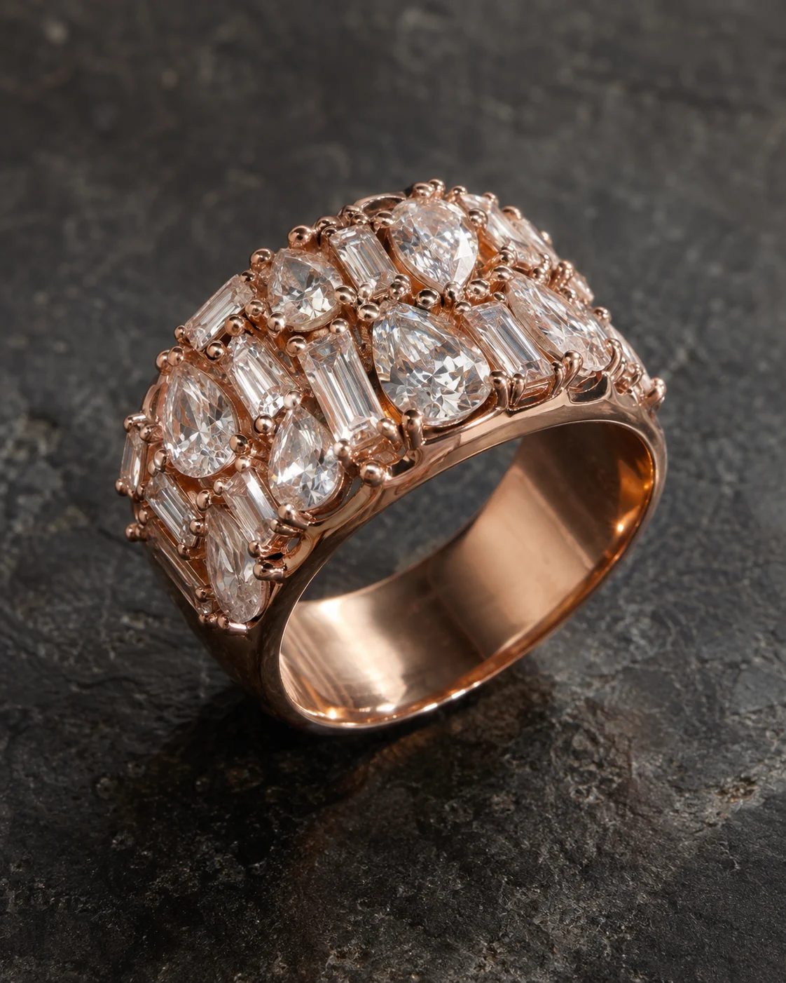 Wide rose-gold-tone statement ring with stones on the crown and a smooth inner band